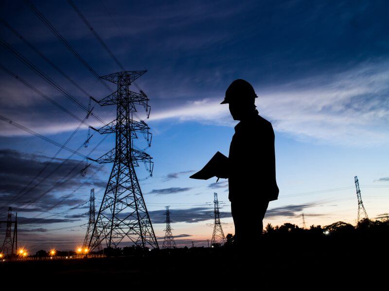 silhouette man of engineers standing at electricity station fieldpro